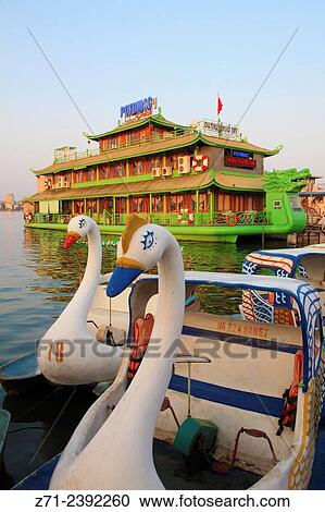 Stock Image - Vietnam, Hanoi, West Lake, floating restaurant, pedal boats,.. Fotosearch
