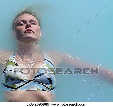 Woman enjoyng the relaxing waters of the Blue Lagoon, Iceland. View Large Photo Image Stock Photo - Woman enjoyng the relaxing waters of the Blue Lagoon, Iceland.. Fotosearch