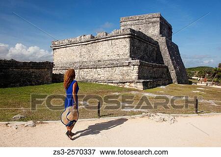 Stock Photo - Woman posing in Mayan Ruins at Maya archeological site of Tulum near the Castle-Castillo, Quintana Roo, Yucatan Province, Mexico, Central America.. Fotosearch