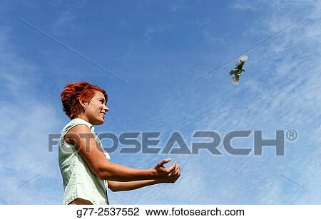 Woman releasing a bird. Budapest, Hungary View Large Photo Image Stock Image - Woman releasing a bird. Budapest, Hungary. Fotosearch