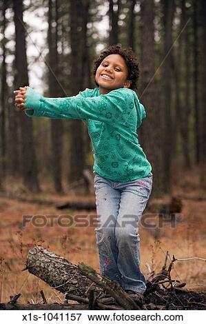 Young African American child playing outside in a wooded area View Large Photo Image Stock Photo - Young African American child playing outside in a wooded area. Fotosearch