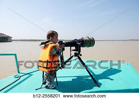 Young child taking pix of wildlife with 600mm lens View Large Photo Image Stock Image - Young child taking pix of wildlife with 600mm lens. Fotosearch