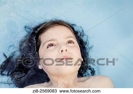 Stock Image - Young girl in swimming pool.. Fotosearch