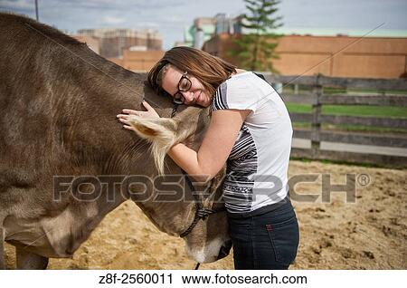 Young woman hugging a cow in College Park, Maryland. USA. View Large Photo Image Stock Image - Young woman hugging a cow in College Park, Maryland. USA.. Fotosearch
