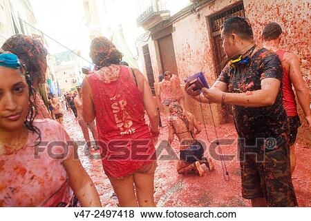 150 tons of tomatoes serve as ammunition for traditional Tomatina, a battle which attracted this year more than 22, 000 people of 96 different nationalities to launch a record number tomatoes. Buñol, Valencia province, Spain. View Large Photo Image Stock Photo - 150 tons of tomatoes serve as ammunition for traditional Tomatina, a battle which attracted this year more than 22, 000 people of 96 different nationalities to launch a record number tomatoes. Buñol, Valencia province, Spain.. Fotosearch