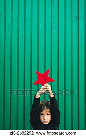 6 years old boy holding a red christmas star. View Large Photo Image Stock Image - 6 years old boy holding a red christmas star.. Fotosearch