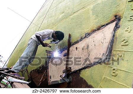 A Bangladeshi laborer works on a ferry being refurbished at a dockyard in Keraniganj, near Dhaka, Bangladesh, Wednesday, Aug. 21, 2013. View Large Photo Image Stock Photo - A Bangladeshi laborer works on a ferry being refurbished at a dockyard in Keraniganj, near Dhaka, Bangladesh, Wednesday, Aug. 21, 2013.. Fotosearch