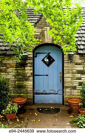A blue door and a stone cottage with a slate roof in a garden setting. Pittsburgh Pennsylvania USA View Large Photo Image Stock Photo - A blue door and a stone cottage with a slate roof in a garden setting. Pittsburgh Pennsylvania USA. Fotosearch