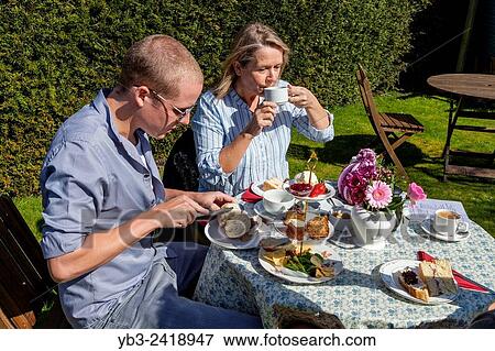 Stock Photo - A Family Enjoy A Traditional English Afternoon Tea, Glynde, Sussex, UK.. Fotosearch