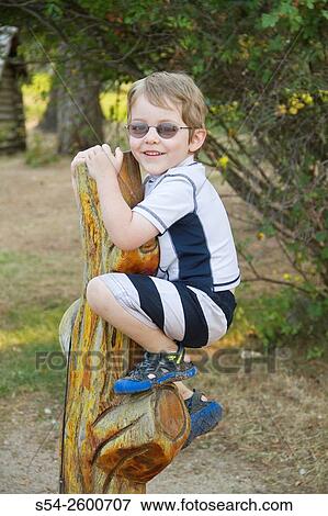 A four-year-old caucasian boy playing outdoors in Priest Lake, Idaho, USA. View Large Photo Image Stock Photo - A four-year-old caucasian boy playing outdoors in Priest Lake, Idaho, USA.. Fotosearch