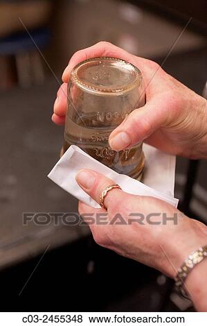 A jar of water with a fine mesh screen top is upended onto a cloth napkin to create a surface tension skin due to the high polarity of water. View Large Photo Image Stock Photo - A jar of water with a fine mesh screen top is upended onto a cloth napkin to create a surface tension skin due to the high polarity of water.. Fotosearch