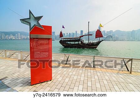 A junk sailing past the Avenue of Stars, Tsim Sha Tsui, Kowloon, Hong Kong, China. View Large Photo Image Stock Photo - A junk sailing past the Avenue of Stars, Tsim Sha Tsui, Kowloon, Hong Kong, China.. Fotosearch