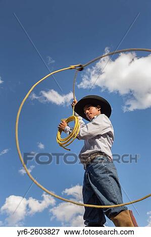 Stock Photo - A Mexican charro or cowboy practices roping skills on his horse before a Charreada competition at a hacienda ranch in Alcocer, Mexico.. Fotosearch