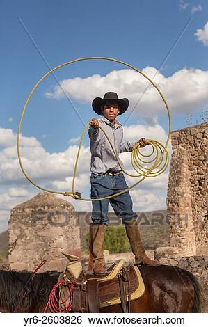 A Mexican charro or cowboy practices roping skills on his horse before a Charreada competition at a hacienda ranch in Alcocer, Mexico. View Large Photo Image Stock Photograph - A Mexican charro or cowboy practices roping skills on his horse before a Charreada competition at a hacienda ranch in Alcocer, Mexico.. Fotosearch