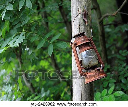 A rusty old lamp hangs forgotten at Vivian Quarry, Llanberis, Snowdonia, Wales, Europe. View Large Photo Image Stock Image - A rusty old lamp hangs forgotten at Vivian Quarry, Llanberis, Snowdonia, Wales, Europe.. Fotosearch