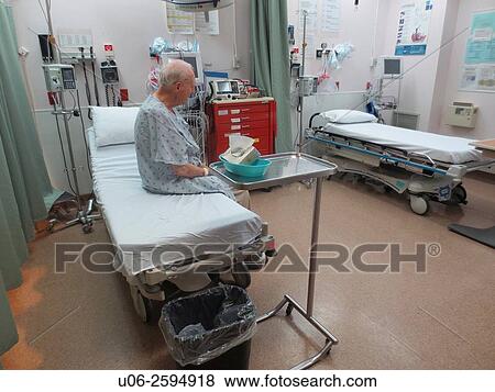 A senior man sitting on an examination bed in emergency at a hospital waiting for a doctor View Large Photo Image Stock Photo - A senior man sitting on an examination bed in emergency at a hospital waiting for a doctor. Fotosearch