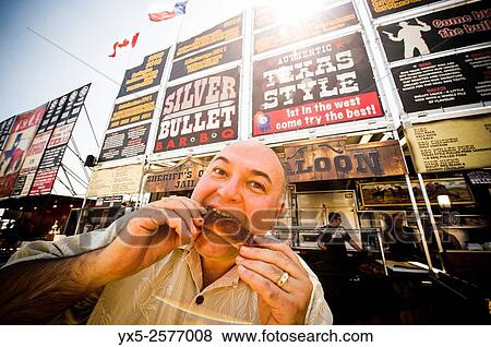 A visitor enjoys pork ribs at Toronto ribfest. The festival attracted scores of Torontonians to the Centennial Park grounds during the long weekend which marked Canada Day celebrated on the 1st of July. View Large Photo Image Stock Photo - A visitor enjoys pork ribs at Toronto ribfest. The festival attracted scores of Torontonians to the Centennial Park grounds during the long weekend which marked Canada Day celebrated on the 1st of July.. Fotosearch