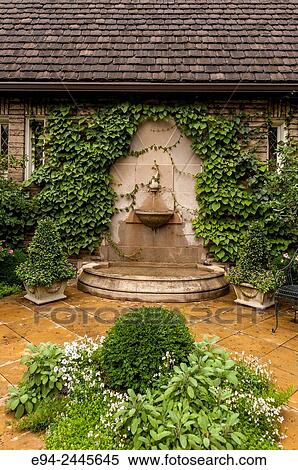 A water feature on a wall in a garden setting. Pittsburgh Pennsylvania USA View Large Photo Image Stock Photography - A water feature on a wall in a garden setting. Pittsburgh Pennsylvania USA. Fotosearch
