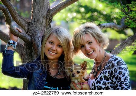 A woman and her daughter outdoors at a park with their dog in Spokane, Washington, USA. View Large Photo Image Stock Photo - A woman and her daughter outdoors at a park with their dog in Spokane, Washington, USA.. Fotosearch