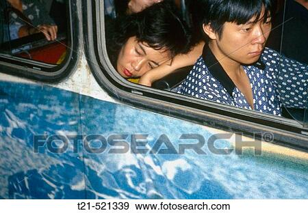 A woman asleep on a public bus in Guangzhou. China. View Large Photo Image Stock Photo - A woman asleep on a public bus in Guangzhou. China.. Fotosearch