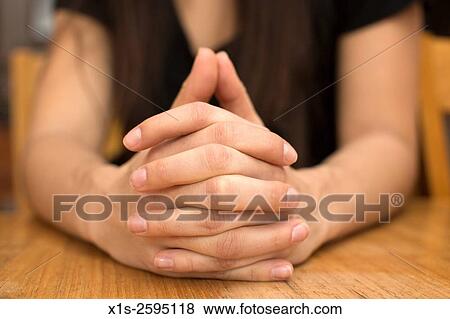A woman´s hands folded together with her fingers interlocked. View Large Photo Image Stock Photo - A woman´s hands folded together with her fingers interlocked.. Fotosearch