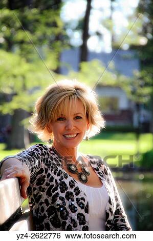 Stock Photograph - A woman sitting outdoors in Spokane, Washington.. Fotosearch