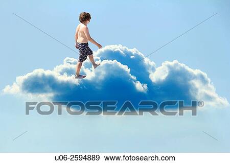 A young boy dreaming of walking on cloud 9 View Large Photo Image Stock Photo - A young boy dreaming of walking on cloud 9. Fotosearch