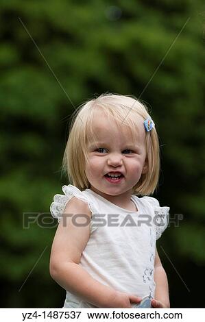 A young Caucasian toddler outdoors making a silly face. View Large Photo Image Stock Photo - A young Caucasian toddler outdoors making a silly face.. Fotosearch