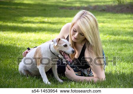 A young lady with her dog in a park View Large Photo Image Picture - A young lady with her dog in a park. Fotosearch