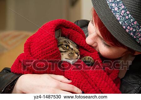A young woman looks at her cat wrapped up in a blanket. View Large Photo Image Stock Image - A young woman looks at her cat wrapped up in a blanket.. Fotosearch