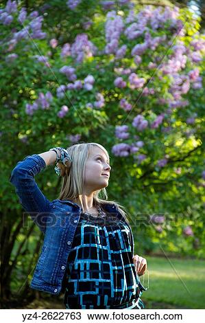 A young woman outdoors in a lilac garden. View Large Photo Image Stock Image - A young woman outdoors in a lilac garden.. Fotosearch