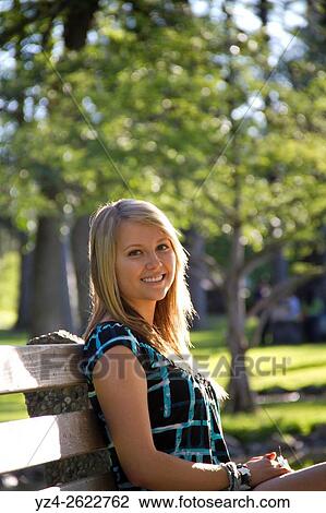 A young woman sitting outdoors at a park in Spokane, Washington, USA. View Large Photo Image Stock Image - A young woman sitting outdoors at a park in Spokane, Washington, USA.. Fotosearch