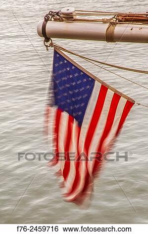 American flag fluttering on the stern of a sailboat in Boston Harbor. View Large Photo Image Stock Photograph - American flag fluttering on the stern of a sailboat in Boston Harbor.. Fotosearch
