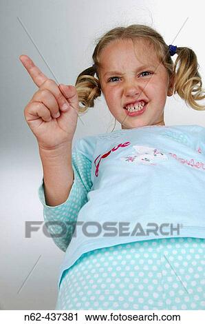 Angry little girl view from below indicates with her index finger on one side View Large Photo Image Stock Image - Angry little girl view from below indicates with her index finger on one side. Fotosearch