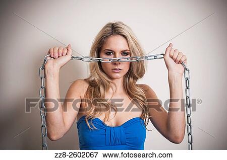 Angry woman holding a metal chain. View Large Photo Image Stock Photo - Angry woman holding a metal chain.. Fotosearch