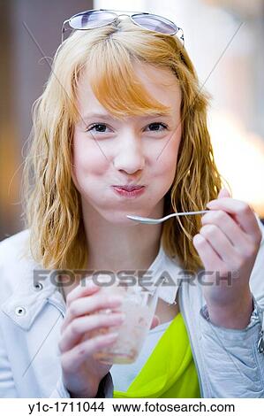 Picture - Attractive teen girl with her mouth full. Fotosearch