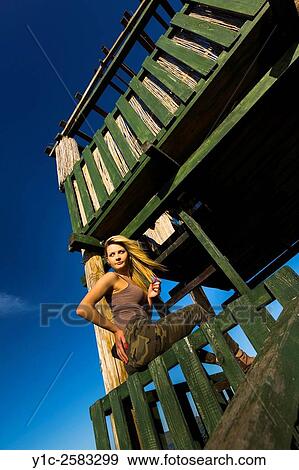 Stock Photo - Attractive young woman on observation tower looking away. Fotosearch