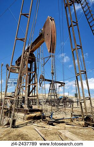 Stock Photo - Azerbaijan, Baku, Bibi Heybat, nodding donkey oil pumps pumping oil up from an oil field.. Fotosearch