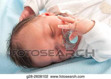 Baby 2 weeks old asleep with dummy comforter in his mouth View Large Photo Image Stock Image - Baby 2 weeks old asleep with dummy comforter in his mouth. Fotosearch