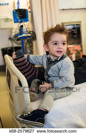 baby boy, 18 months old, on a hospital bed with his father View Large Photo Image Stock Photo - baby boy, 18 months old, on a hospital bed with his father. Fotosearch