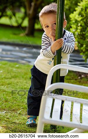 Baby playing in the park. Getaria. Gipuzkoa. Basque Country. Spain View Large Photo Image Picture - Baby playing in the park. Getaria. Gipuzkoa. Basque Country. Spain. Fotosearch