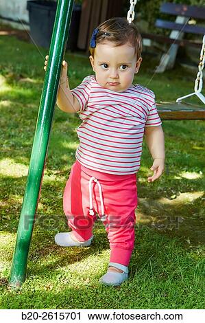 Stock Image - Baby playing in the park. Getaria. Gipuzkoa. Basque Country. Spain. Fotosearch