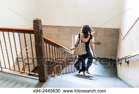 Back view of a young woman rushing down a stairway in an old building. Pittsburgh Pennsylvania, University of Pittsburgh View Large Photo Image Stock Image - Back view of a young woman rushing down a stairway in an old building. Pittsburgh Pennsylvania, University of Pittsburgh. Fotosearch