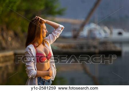 Beautiful teen girl in bikini and White shirt hand on tummy View Large Photo Image Stock Photo - Beautiful teen girl in bikini and White shirt hand on tummy. Fotosearch