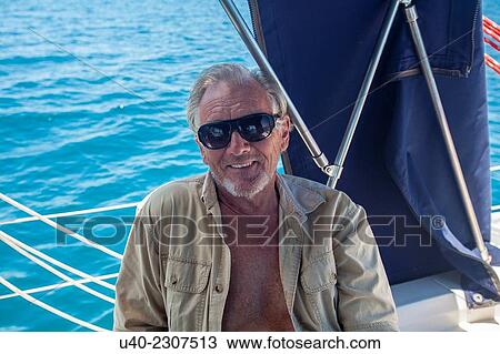 Belize, Captain in cockpit of sailboat. View Large Photo Image Stock Image - Belize, Captain in cockpit of sailboat.. Fotosearch