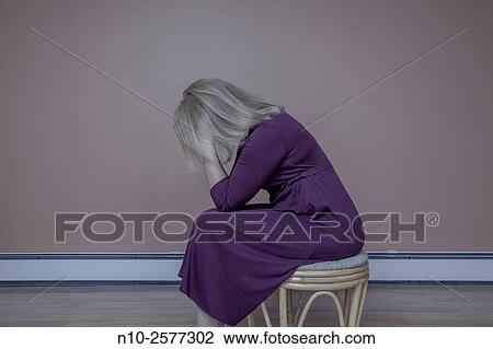 Blond woman sitting on a stool. View Large Photo Image Stock Image - Blond woman sitting on a stool.. Fotosearch