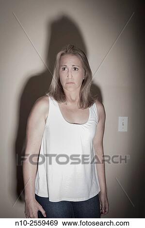 Stock Photo - Blond woman with a large shadow.. Fotosearch