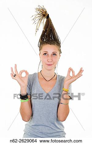 Blonde girl with funny expression doing yoga with pigtails raised vertically on her head. View Large Photo Image Picture - Blonde girl with funny expression doing yoga with pigtails raised vertically on her head.. Fotosearch
