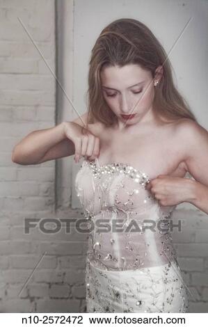 Blonde teenage girl adjusting her dress. View Large Photo Image Stock Image - Blonde teenage girl adjusting her dress.. Fotosearch