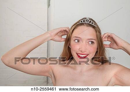 Blonde teenage girl adjusting her headpiece. View Large Photo Image Stock Image - Blonde teenage girl adjusting her headpiece.. Fotosearch
